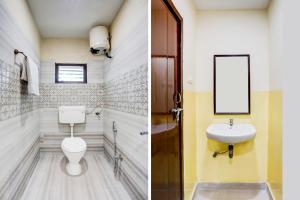 a bathroom with a toilet and a sink at Super Hotel O Rajahmundry Central Railway Station Formerly Sanjeevi Residency in Godāvari
