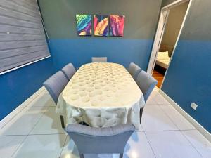 a white table and chairs in a room at IMAGO The Loft Kota Kinabalu City Centre by LW Suites in Kota Kinabalu +4 photos