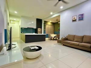 a large living room with a couch and a kitchen at IMAGO The Loft Kota Kinabalu City Centre by LW Suites in Kota Kinabalu