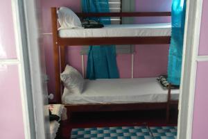 two bunk beds in a room with a mirror at Jay's Guest House in Epping Farm