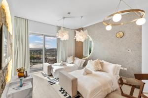 a bedroom with two beds and a couch at Luxury Waters Edge Residence in Yas Island +64 photos