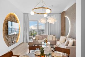 a living room with a couch and a table at Luxury Waters Edge Residence in Yas Island