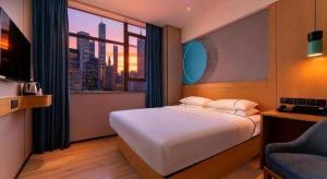 Ένα ή περισσότερα κρεβάτια σε δωμάτιο στο City Comfort Inn Ganghui Shopping Center