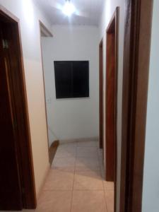 un corridoio con televisore in una stanza bianca di Casa Petrópolis a Petrópolis
