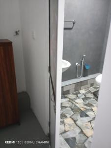 a bathroom with a sink and a tub and a toilet at DiDi Eco Home in Weligama