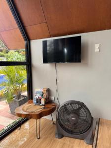 a room with a fan on a wall with a table at Everleigh Resort in Mataasnakahoy
