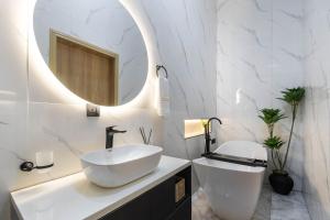 a white bathroom with a sink and a mirror at Modern 3BR Smart Villa near Lekki Conservation with Inverter PS5, Hot Tub and Gym in Ibeju +22 photos