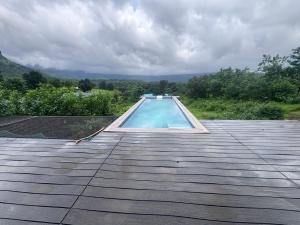 a swimming pool on the roof of a house at Silvaate stay in Karjat