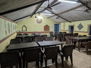 an empty dining room with tables and chairs at RANN STAR VILLAGE STAY in Dhordo