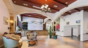 a large lobby with chairs and a large screen at GreenTree Alliance Hotel Shanghai Baoshan District Meilan Lake Yueluo Road in Luodian