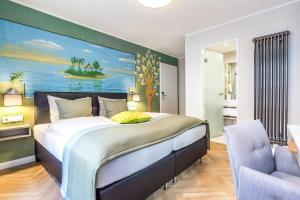 a bedroom with a large bed with a painting on the wall at Burghotel Lingen in Lingen
