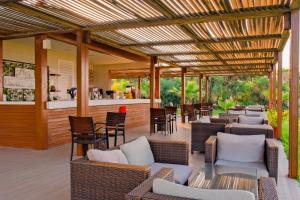 a patio with chairs and tables and a bar at Sural Hotel in Side