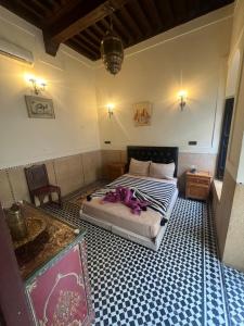 a bedroom with a large bed and a room with at Riad Mamma MARRAKESH in Marrakech