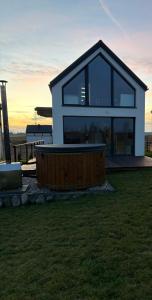 a house with a large window and a fence at MAZURSKi DOM NAD WODĄ 