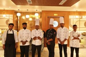 a group of chefs posing for a picture in a kitchen at Hotel HPB Grand in Bhadohī +3 photos