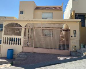 a house with a gate in front of it at Casa al Norte bien ubicada, portón control remoto in Ramos Arizpe