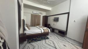 a hotel room with a bed and a mirror at Airways Inn in Tikri Kalān