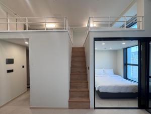 a bedroom with a bunk bed and a staircase at Namsan Dream City in Seoul