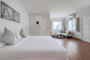 a white bedroom with a large white bed in a room at Blissful Heaven Residence at BTS Phromphong Emdistrict Shopping Area in Bangkok +42 photos