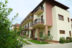 a building with balconies on the side of it at Pensiunea Genesa in Timişoara