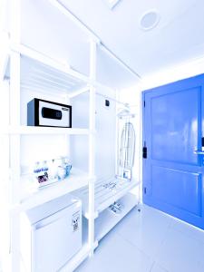 a room with white shelves and a blue door at Jungwok Blue Ocean Resort in Ngandong +36 photos