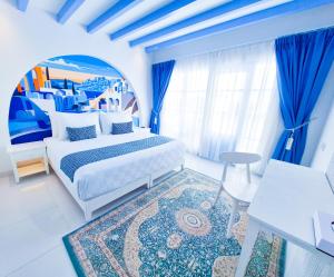 a bedroom with a large bed and blue curtains at Jungwok Blue Ocean Resort in Ngandong