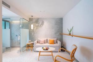 a living room with a couch and a table at Wyndham Garden Phuket Kamala in Kamala Beach