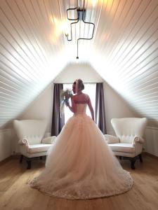 a woman in a wedding dress standing in a room at Serguzest Otel in Buyukada