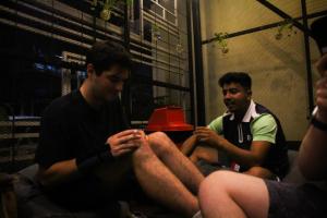 two men sitting on a couch with their legs crossed at Here We Go Bangkok in Bangkok +49 photos