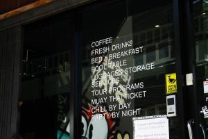 a window with a bunch of signs on it at Here We Go Bangkok in Bangkok