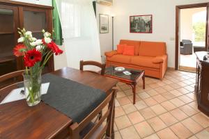 a living room with a vase of flowers on a table at Villa Eleanto in Cefalù