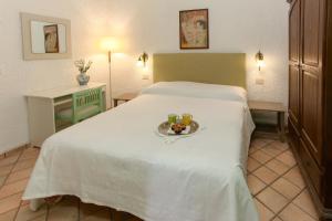 a hotel room with a bed with a tray of food on it at Villa Eleanto in Cefalù