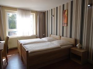 Postel nebo postele na pokoji v ubytování Hotel am Schloss