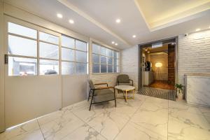 a room with a table and chairs and a fireplace at 광안비치호텔더엠 in Kwangan-dong