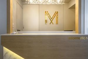 a museum with a large m sign on a wall at 광안비치호텔더엠 in Kwangan-dong