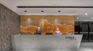 two women sitting at a counter in an office at Meet Garden Hotel Baiyun International Airport in Guangzhou