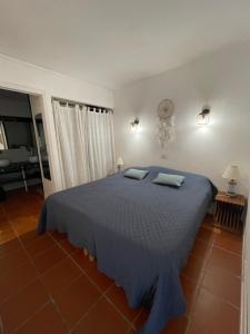 a bedroom with a blue bed with two pillows on it at Ti coin de paradis Anse des Rochers in Saint-François +38 photos
