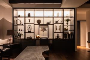 a room with a wall of shelves with vases at Rairin in Hiroshima