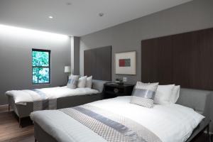 a hotel room with two beds and a window at Rairin in Hiroshima