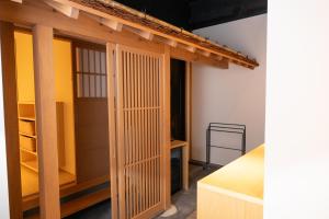 a room with a closet with wooden doors at Rairin in Hiroshima +66 photos