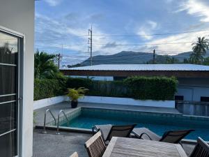 einen Pool mit einem Tisch und Stühlen neben einem Haus in der Unterkunft 2 Bed 2 Bath Private Pool Villa Near Beach in Nathon Bay