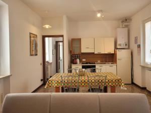a kitchen with a table and a kitchen with a refrigerator at La casa di Sergiò in Belgioioso +7 photos