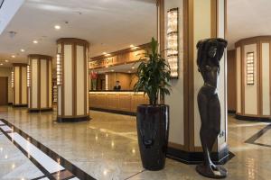 a statue of a woman standing in a lobby at Maritim Hotel Dresden in Dresden +32 photos
