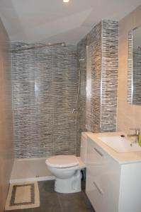 a bathroom with a toilet and a sink and a shower at Margarita Apartment Benidorm in Benidorm