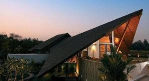 a house with a black roof on top of it at Azaya Villas Resort in Ban Mai Na Hi