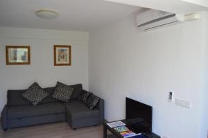 a living room with a couch and a tv at Margarita Apartment Benidorm in Benidorm