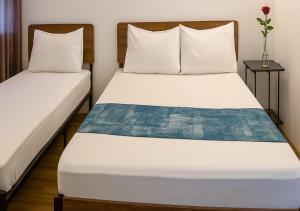 two beds in a room with two pillows at Arrival View in Male City