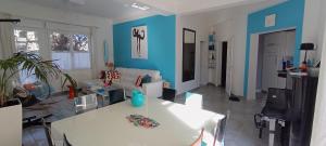 a living room with a white table and blue walls at La Pause Bleue in Dinard +11 photos