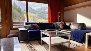 a living room with a couch and a table at Chalet Engelberg Mountain View in Engelberg +12 photos