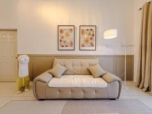 Una sala de estar con un sofá y una lámpara. en Family-Friendly Landed 2BR 8 Pax Netflix and WiFi, en Kamunting